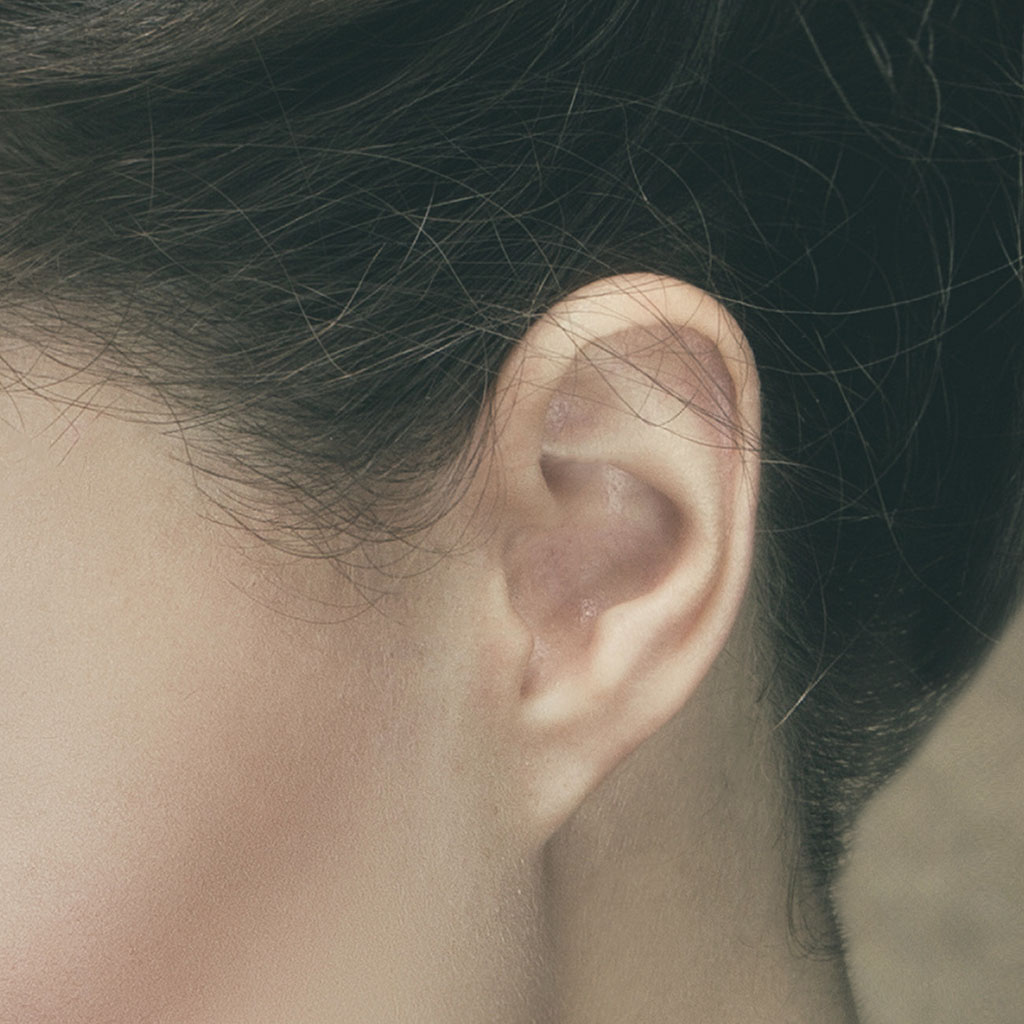 Closeup of portrait showing stray hairs over model's ear