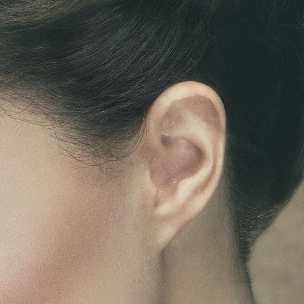 Closeup of model's ear with stray hairs removed